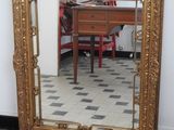 a large mirror sitting on the floor next to a table