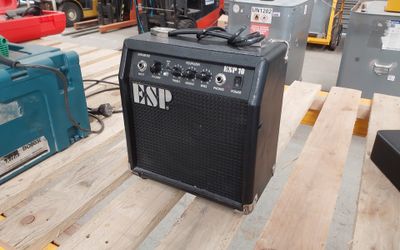 a guitar amp sitting on a pallet in a warehouse