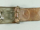 a brown belt with a metal buckle on it