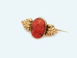 an image of a gold and red broochle broochle broochle