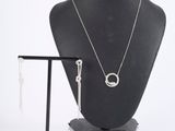 necklace and earrings on a mannequin stand with a white background