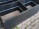 a black wooden box that is sitting on the ground