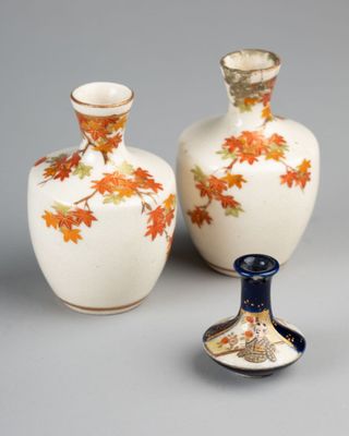 two vases sitting next to each other on a table