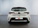 the rear end of a white toyota corollant parked in a white room