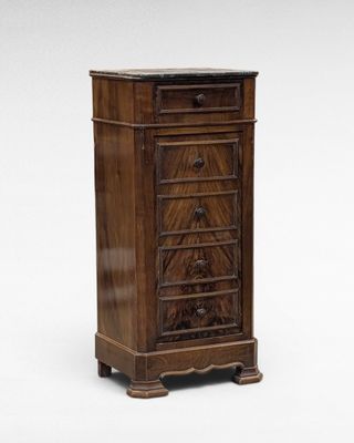 an antique wooden chest of drawers with a marble top