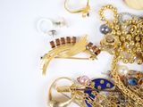 a pile of jewelry on a white surface