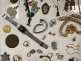 many different types of jewelry displayed on a table