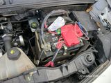a car battery in the engine bay of a car