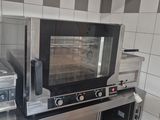 a small oven that is sitting on a counter in a kitchen
