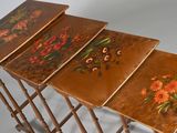 three wooden tables with painted flowers on them sitting on a white surface