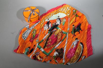 a picture of an orange hat with a picture of a woman on it
