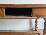 a wooden desk with a drawer on top of it