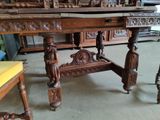 a table that has a lot of carvings on it