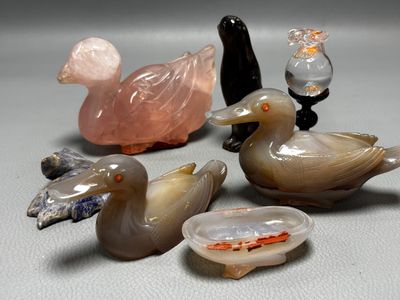 a lot of glass ducks that are sitting on a table