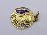 an image of a gold pendant with a hand holding a star