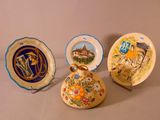 three decorative plates sitting on a table next to each other