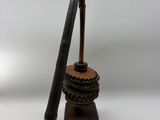 a small wooden object with a wooden stick on top of it