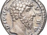 a silver coin with an image of a man ' s head on it