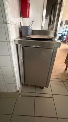 a silver dishwasher sitting in the corner of a kitchen