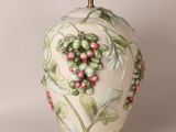a white vase with a green and red design on it