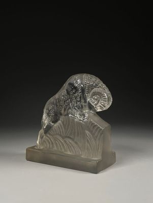 an image of a glass sculpture of a ram on a rock