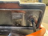 a close up of an orange handle on a metal object