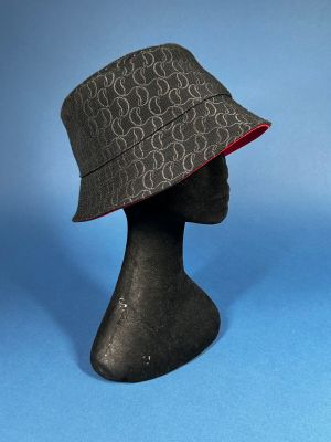 a close up of a hat on a mannequin head on a blue background