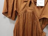 an image of a dress hanging on a hanger on a wall