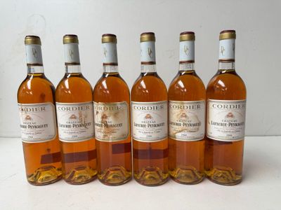 six bottles of wine are lined up in a row on a table