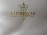 the logo for orbrille is gold on a white shirt