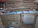 a television sitting on top of a cardboard box in a warehouse