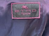 the back of a purple jacket with a pink logo on it