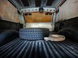 a tire on the bed of a truck with a roll of tape