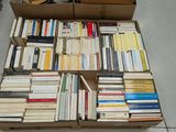 boxes of books are stacked on top of each other on the floor
