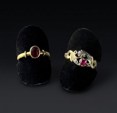 a pair of gold rings with ruby stones and diamonds