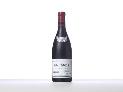 a bottle of red wine sitting on top of a table