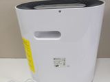 a white and black air purifier on a white table
