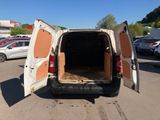 a white van with its door open in a parking lot