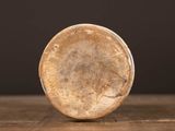a close up of a coin on a wooden table