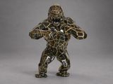 a close up of a figurine of a gorilla on a gray background