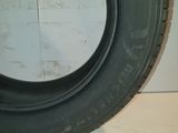 tire on the floor of a garage with a white wall in the background