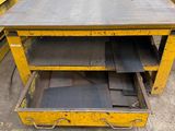 a table that is sitting on top of a table in a warehouse