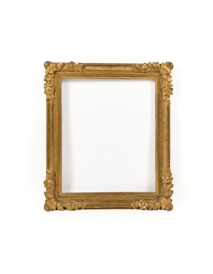 a gold frame on a white wall with a white background