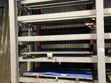 a large rack with a mattress on it in a warehouse