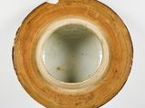 a brown vase that has a hole in the middle of it