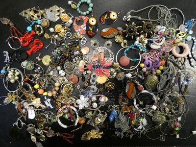 a black table with a bunch of jewelry on it