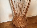 a wicker chair that is sitting on a wooden floor