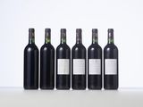 six bottles of wine are lined up on a table