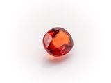 a red garnet stone on a white background