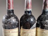 three bottles of wine sitting on top of a table next to each other